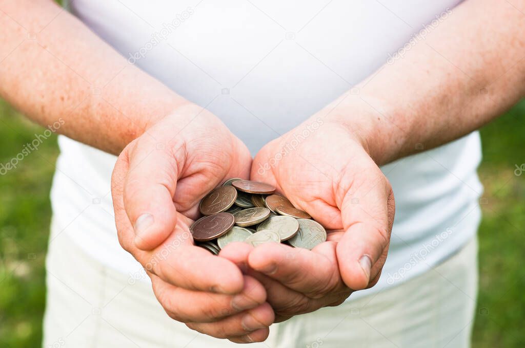 Business people use two hands to hold a lot of coins, costs and planning concept