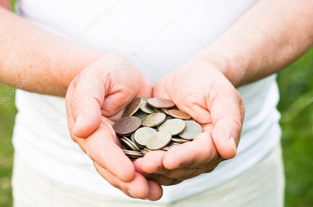 Business people use two hands to hold a lot of coins, costs and planning concept