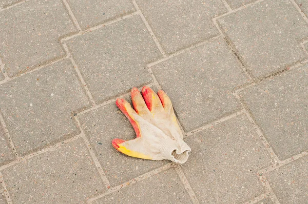 work glove on the sidewalk, occupational Safety and Health