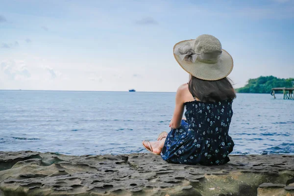 Asian woman tourists watching the sea view and admiring And the clear skies with beautiful clouds. Suitable for tourism, recreation and relax. at  Koh Kood Thailand.