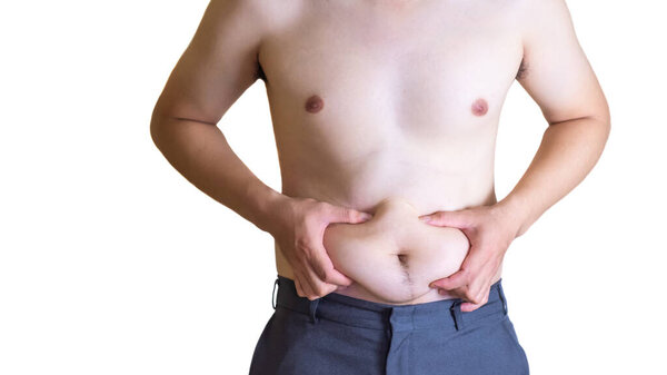 The young man has a fat belly. Have a lot of belly fat Which is not good for his health Causing disease to him. On White background and clipping path.