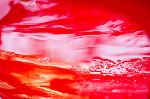 Red plastic surface in water, abstract background