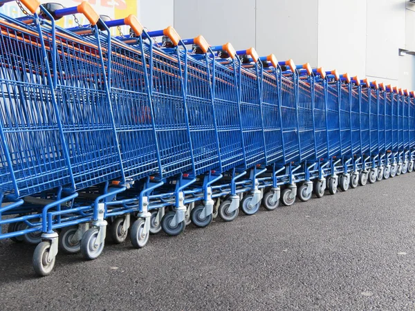 beautiful supermarket carts piled up in line waiting to be caught to transport goods