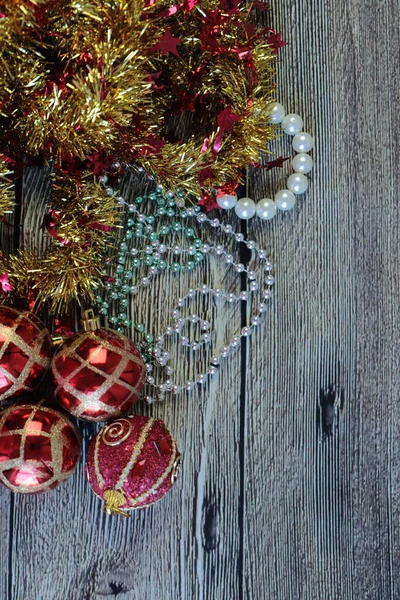 Christmas Decoration isolated on the wooden background. Balls , beads and tinsel — Stock Photo, Image