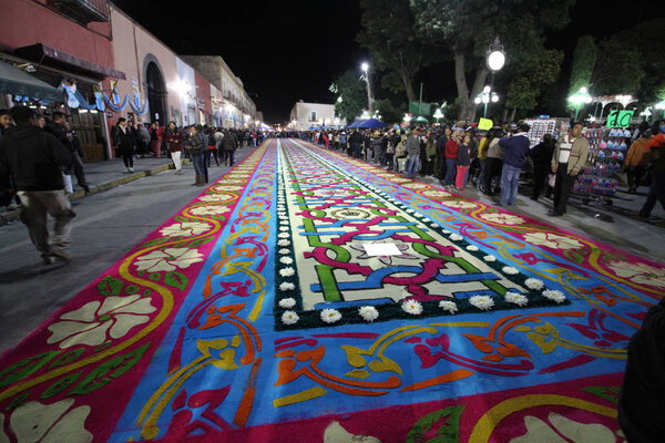 Tlaxcala, Mexico. August 15, 2017. "The night that no body sleeps" is a celebration where the virgin goes around the town over beautiful sawdust tapetes.