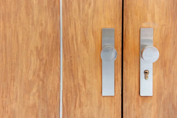 Modern wooden door with metal door handle over — Stock Photo, Image