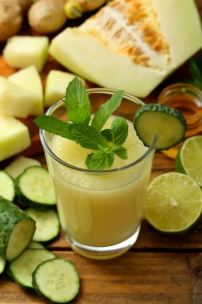 close-up view of fresh healthy melon and cucumber smoothie in glass