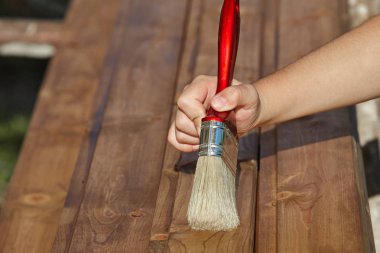 Dekoratör kahverengi boya ile ahşap boyama. İnşaat konsepti.