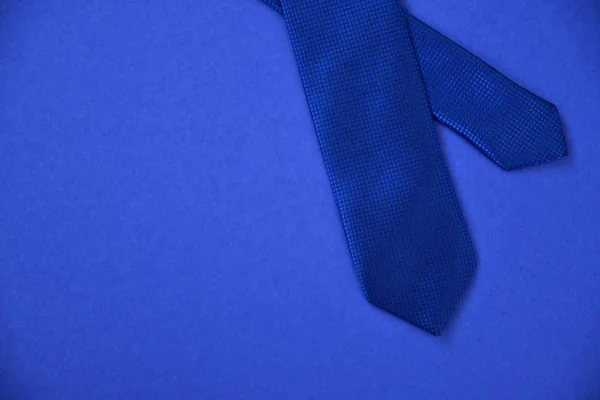 Blue tie on a blue background — Stock Photo, Image