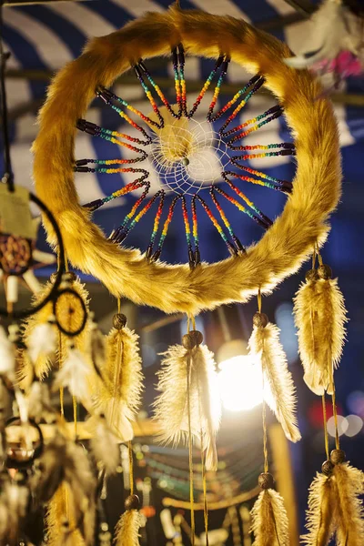 Indian dream catcher with rainbow beads yellow fur and feather