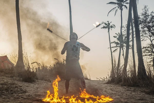 stock image Man doing fire show at Arambol beach in India