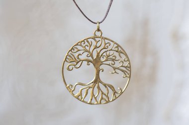 Nötr arka plan üzerinde Pirinç metal ağaç şeklinde kolye yuvarlak mandala