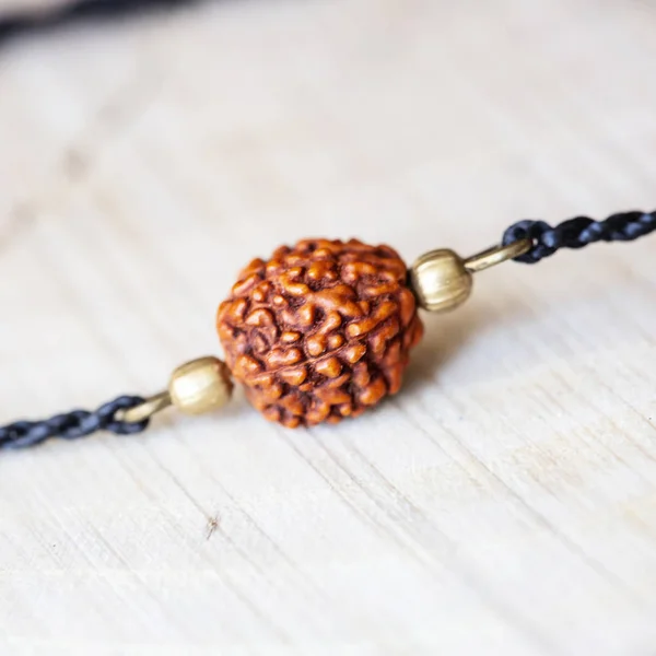 Natural rudraksha seed bead bracelet on pearl background