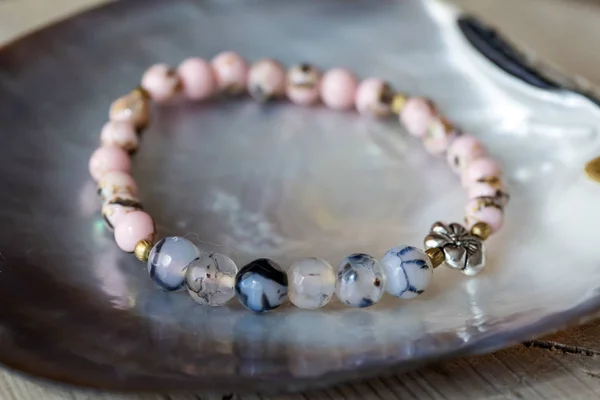 Natural mineral stone bracelet on wooden background