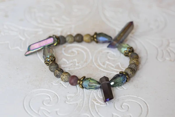 Mineral stone bracelet on natural neutral decorative background