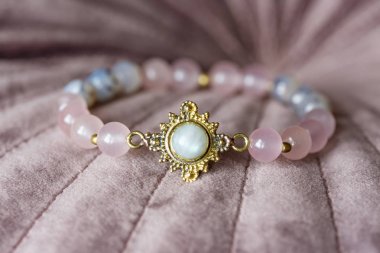 Beautiful mineral stone bracelet on pink velvet clipart