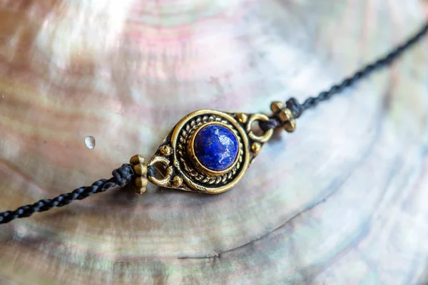 Elegant tiny bracelet with crystal gemstone lapis lazuli on waxed string
