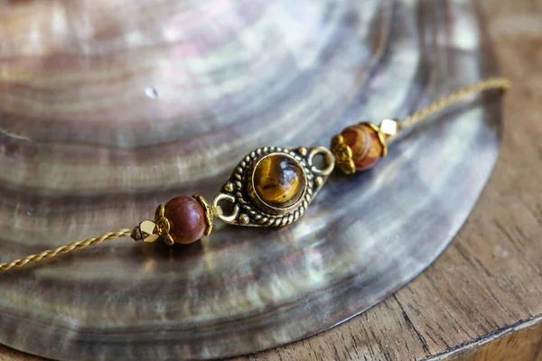 Elegant tiny bracelet with crystal gemstone tiger eye on waxed string