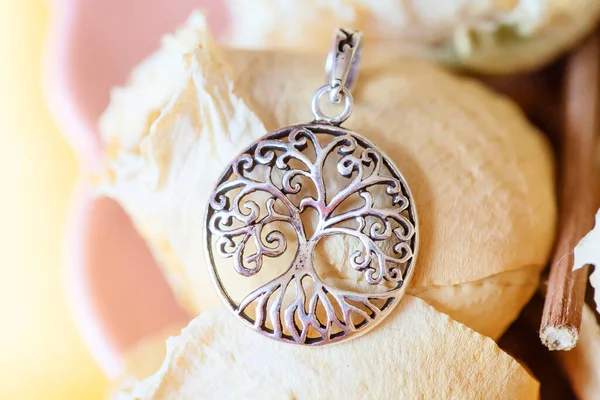 Detail of sterling silver pendant in the shape of tree in mandala