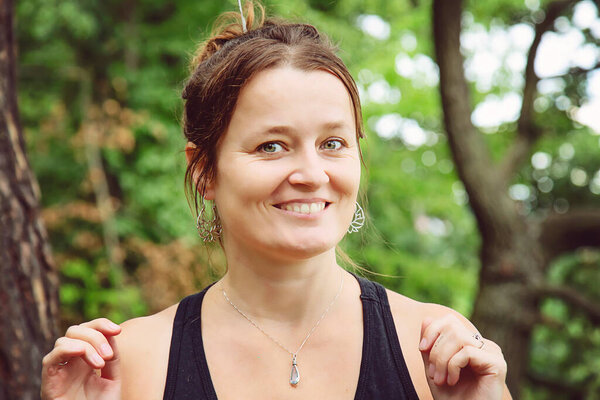 Outdoor portrait of a woman wearing silver metal earrings 