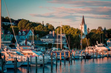 Saint Anne kilisesi ve tarihi Viktorya evleri ile Mackinac Adası'nda Marina Michigan Gölü'nden bir gün batımı çekim