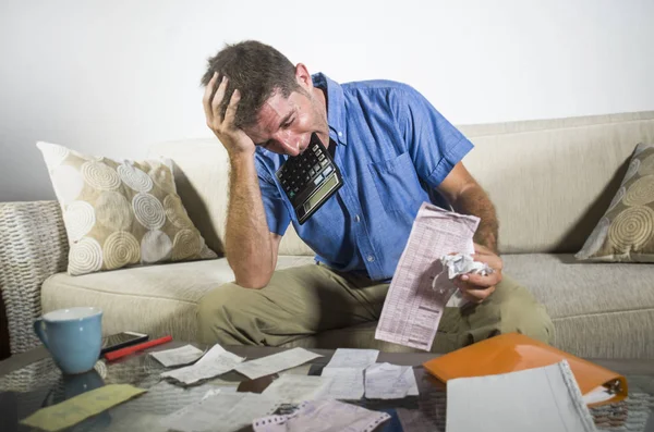 Young Stressed Overwhelmed Man Biting Calculator Holding Mess Bank Receipts — Stock Photo, Image