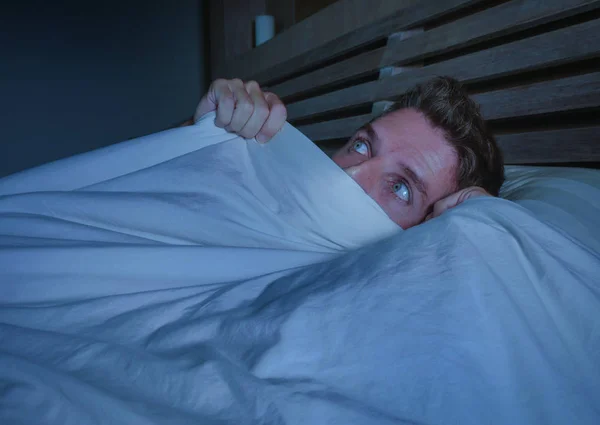공포와 개념을 어두운 침실에 침대에 담요로 얼굴을 고통에서 매력적인 남자의 — 스톡 사진