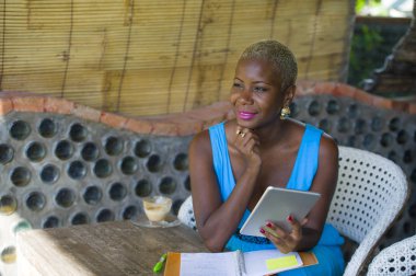 Dijital tablet pad ağ mutlu ve neşeli internet online iş ve girişimci başarı kullanarak trendy kahve dükkanında çalışan genç şık ve zarif siyah Afrika kökenli Amerikalı iş kadın