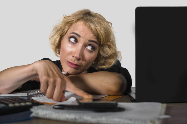 office portrait of young sad and depressed business woman working lazy at laptop computer desk feeling bored and tired looking thoughtful and pensive in work routine and job problem 