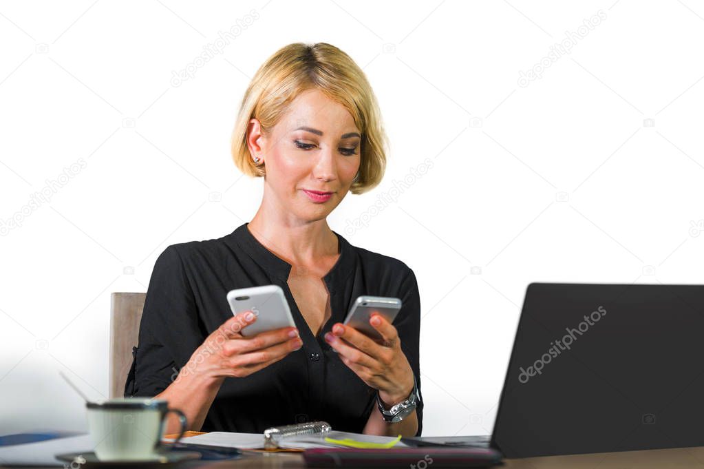 office corporate portrait of young beautiful and happy business woman sitting at laptop computer desk busy with mobile phones confident in job success concept isolated on white background