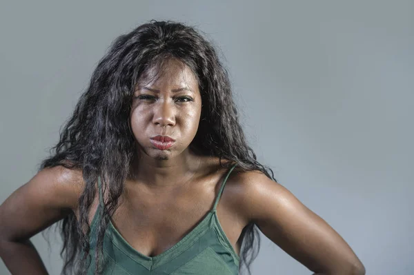 young beautiful and stressed black African American woman feeling upset and angry gesturing agitated and pissed looking crazy and furious arguing or having dispute isolated on studio background