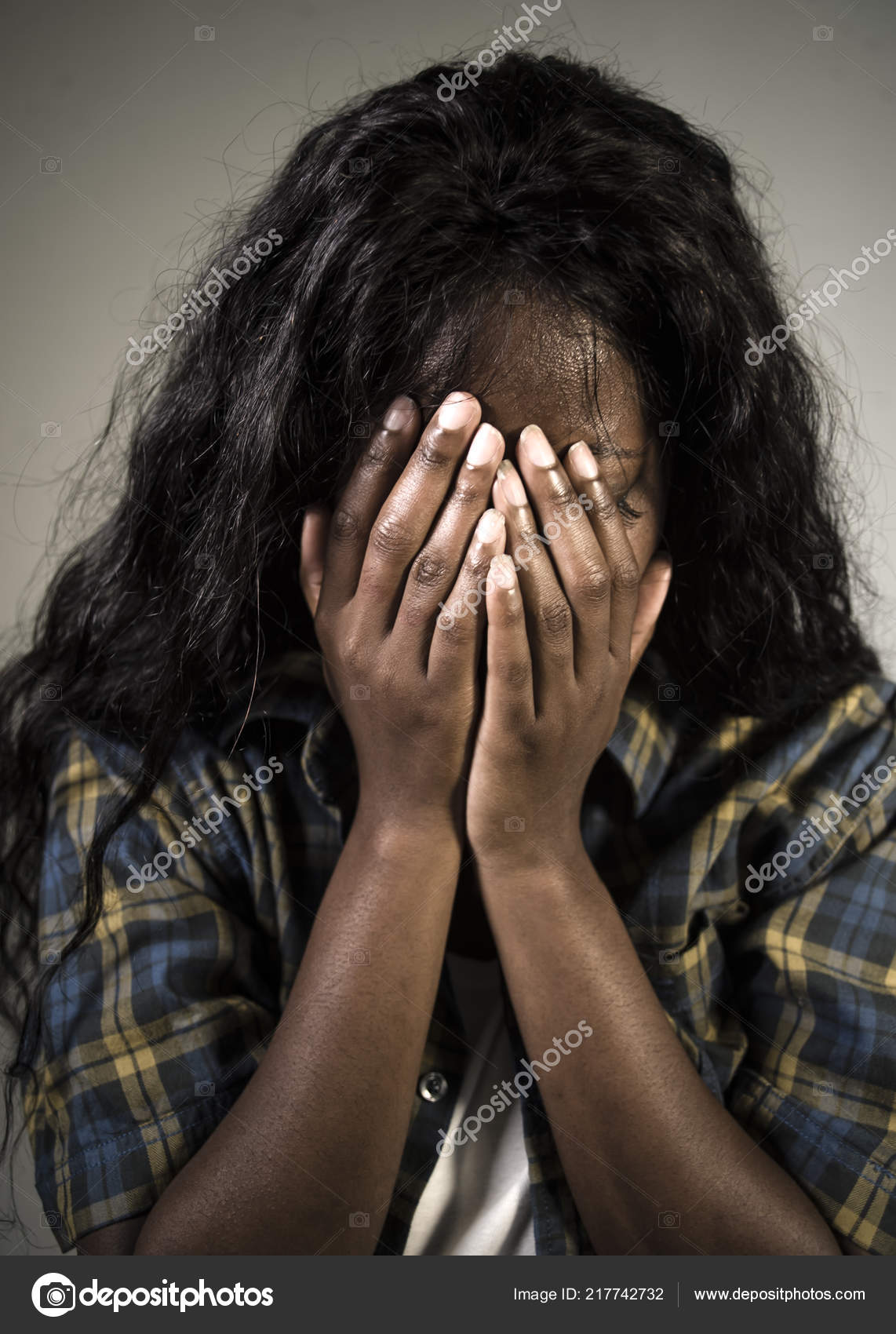 Triste Mulher Sentada Em Um Fundo Negro Foto de Stock - Imagem de