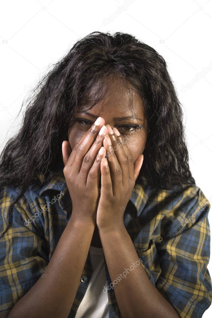young sad and depressed black African American woman crying anxious and overwhelmed feeling sick and stressed isolated on studio background suffering depression problem and anxiety crisis