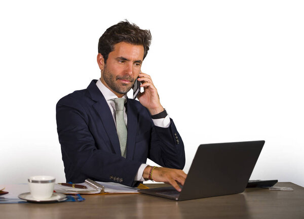 company corporate isolated portrait of young handsome and attractive businessman working at office desk talking on mobile phone confident in finance success and executive lifestyle