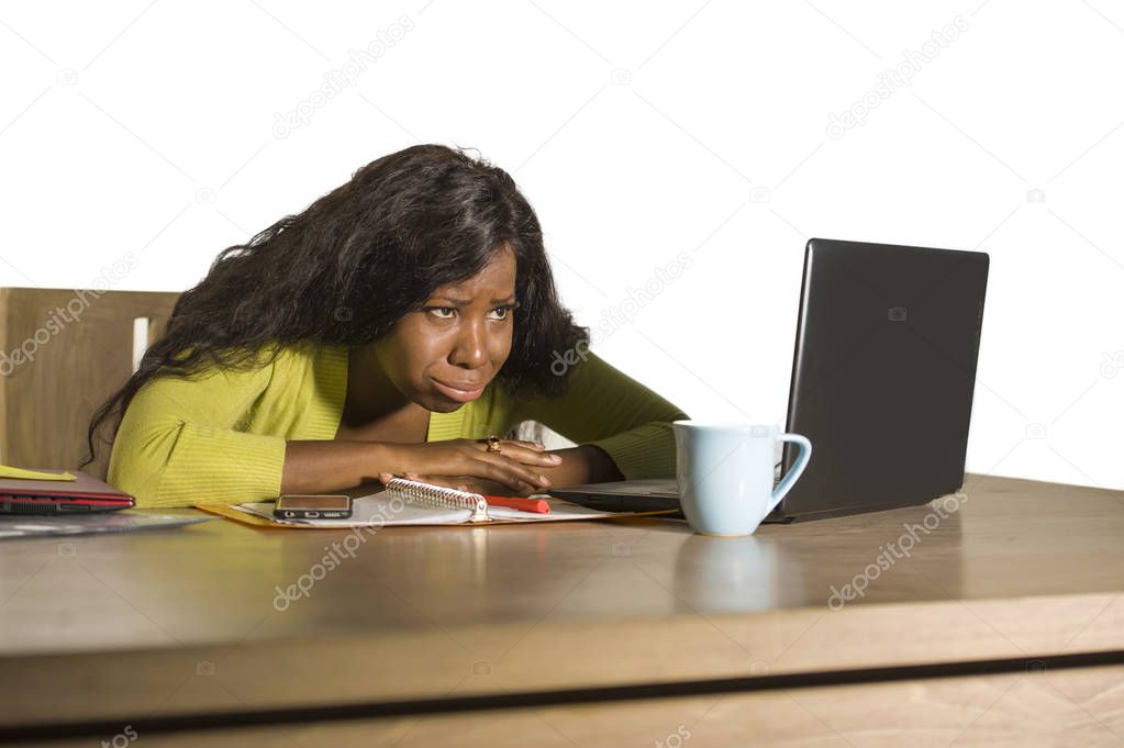 young attractive unhappy and exhausted black afro American woman working lazy on Monday at office computer desk feeling overwhelmed bored and frustrated in business job problem