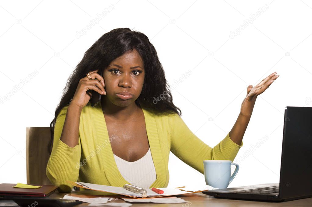 young attractive and busy black afro American business woman working at home office computer desk talking on the phone stressed isolated on white background stressed in upset mood