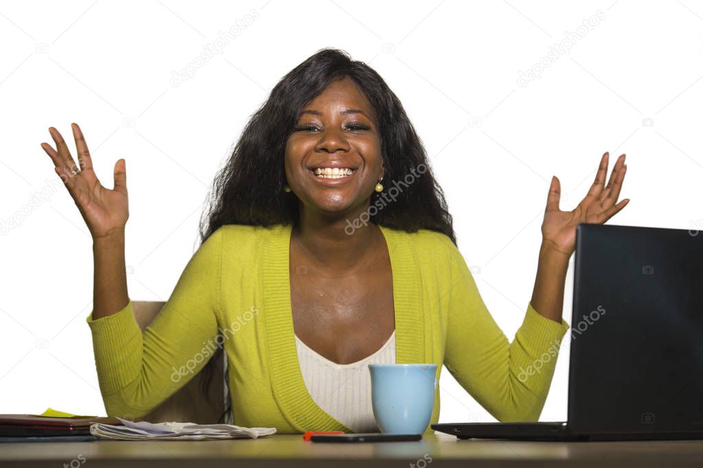 young happy and attractive black afro American business woman smiling cheerful and confident working at office computer desk celebrating success and job promotion isolated on white background
