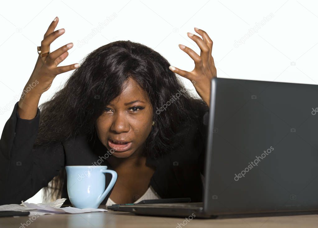 young depressed and overwhelmed black African American business woman working frustrated at office computer desk feeling upset and overworked suffering stress and anxiety problem