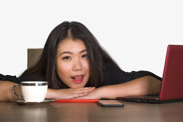 young beautiful and happy Asian Chinese business woman working relaxed at corporate company computer desk smiling cheerful  as successful investor or CEO in job lifestyle concept