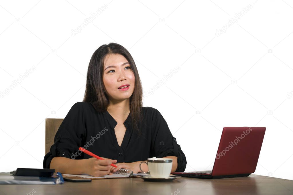 young beautiful and happy successful Asian Chinese business woman working relaxed at office computer desk smiling thoughtful and sweet in success and entrepreneur lifestyle concept