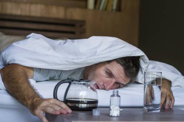 Genç yaşam tarzı ev portresi bitkin ve adam yatakta hasta ve zavallı hala sarhoş yatarken gece partide alkol içtikten sonra baş ağrısı ve akşamdan kalma acı uyanma boşa