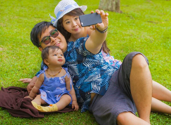 有爱心的亚洲华人家庭 父母和可爱的小女儿在城市公园与父亲一起自拍手机 在互联网社交媒体上上传 — 图库照片