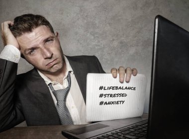 Ofis bilgisayar masası Not defteri hashtags ile tutarak stres çalışan genç depresif ve hayal kırıklığına uğramış işadamı stres hayat dengesi ve iş soruna bir çözüm ile ilgili