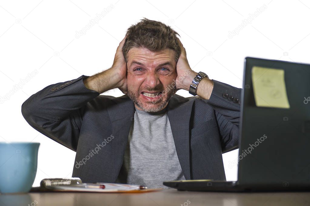 young attractive depressed and frustrated man working at office computer desk desperate and overwhelmed feeling upset suffering depression and anxiety crisis in financial business problem