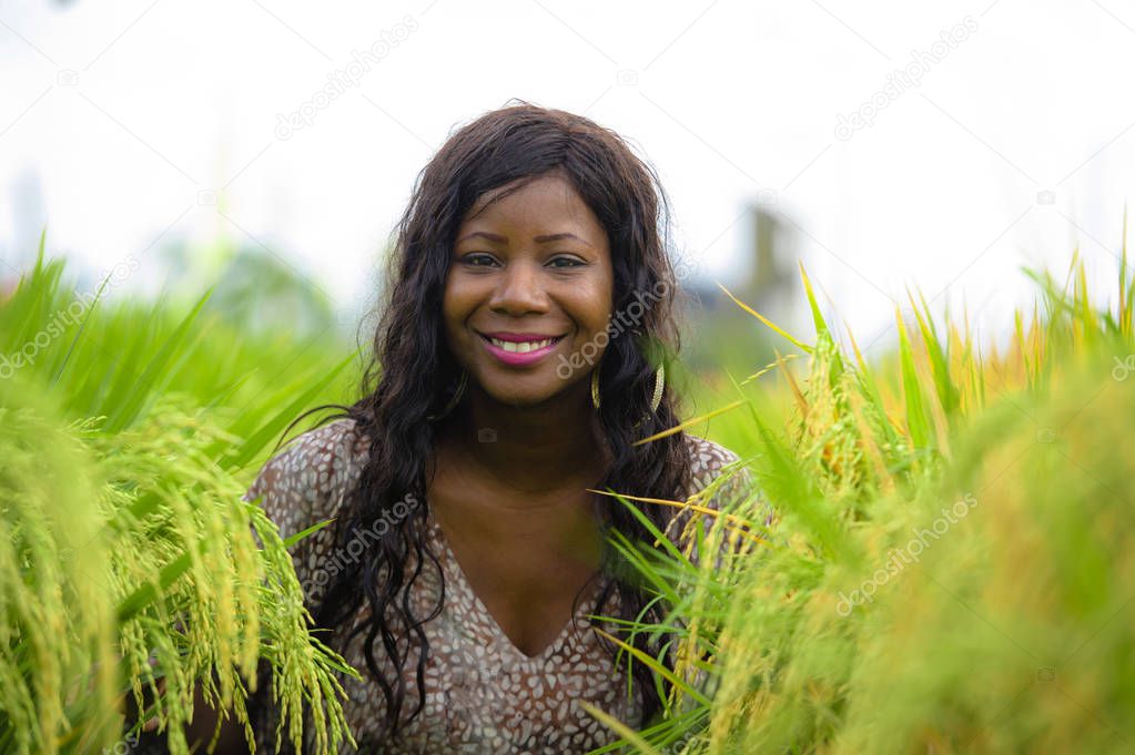 outdoors fresh portrait of young beautiful and happy black African American woman in cool dress having fun at tropical rice field enjoying exotic holidays trip in Asia exploring traditional village