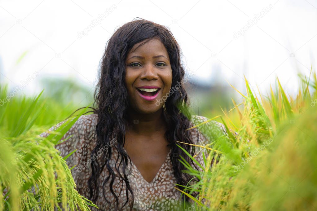 outdoors fresh portrait of young beautiful and happy black afro American woman in cool dress having fun at tropical rice field enjoying exotic holidays trip in Asia exploring traditional village