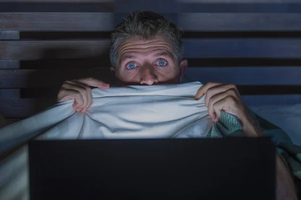Lifestyle Portrait Young Scared Stressed Man Bed Watching Internet Horror — Stock Photo, Image