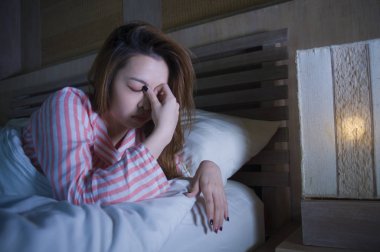 yatak gece uyanık düşünceli uykusuzluk uyku bozukluğu duygu yorgun acı ve kadın depresyon kavramı içinde endişeli bakarak yalan genç güzel üzgün ve depresyonda Asyalı Koreli kız