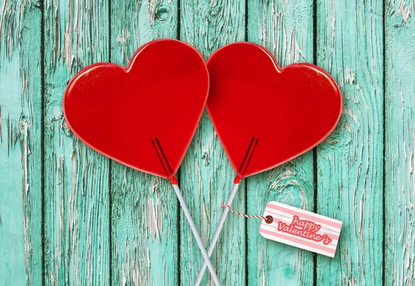wall paper Valentines day greeting card with couple of red heart shape lollipops together isolated on vintage wooden table celebrating romantic holiday in love and relationship concept