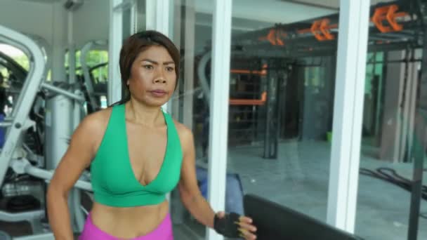Young fit and athletic Asian Thai woman with fit body running on gym treadmill sweating training hard jogging workout in fitness and healthy lifestyle concept — Stock Footage Young Fit Athletic Asian Thai Woman Fit Body Running Gym Royalty Free Stock Footage